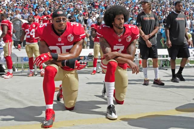 Colin Kaepernick, right, was first to take a knee and was later joined by teammate Eric Reid.
