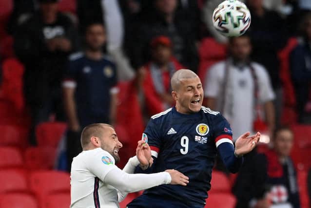 Scotland striker Lyndon Dykes leaves his mark on England defender Luke Shaw in the opening minute of the Euro 2020 Group D match at Wembley. (Photo by Andy Rain - Pool/Getty Images)