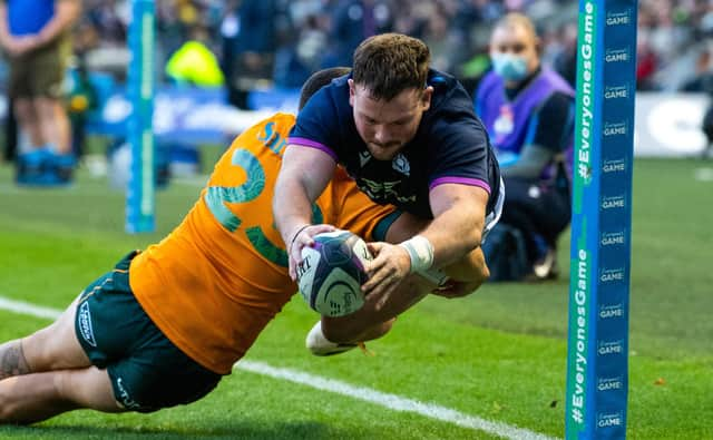 An airborne Ewan Ashman scores Scotland’s second half try in the 15-13 win over Australia. (Photo by Ross Parker / SNS Group)