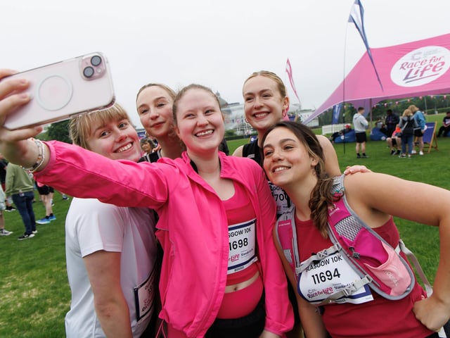 Runners capture the moment as Glasgow city centre is brought to a standstill by the race. PIC: Steve Welsh.