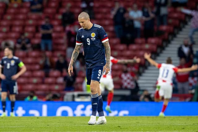 Scotland's Lyndon Dykes looks on dejectedly after a 3-1 defeat by Croatia.