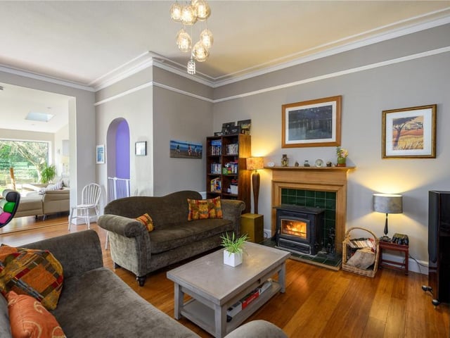The family room has a nice seating area with log burning stove.