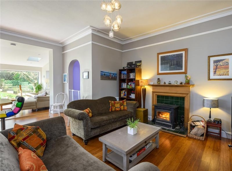 The family room has a nice seating area with log burning stove.