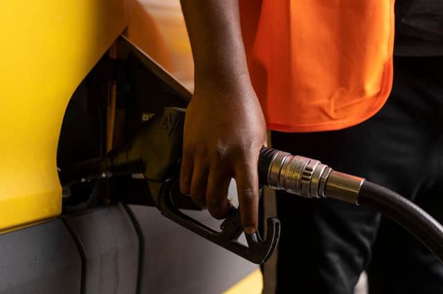 A man puts fuel in his van on a petrol station forecourt as prices rose to £100 to fill an average car.
