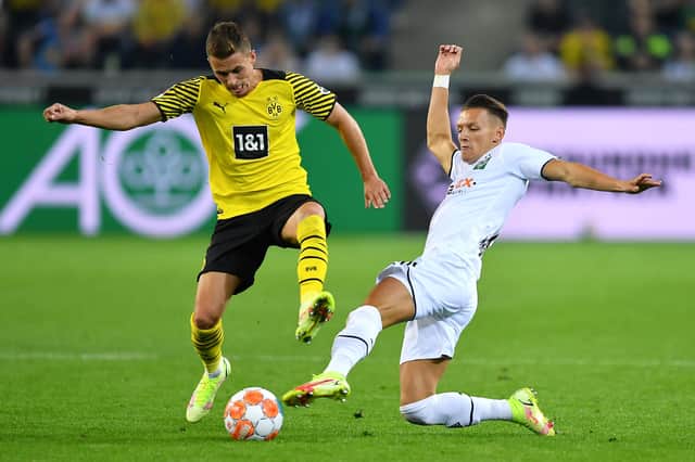 Hannes Wolf of Borussia Moenchengladbach, right, tackles Thorgan Hazard of Borussia Dortmund.