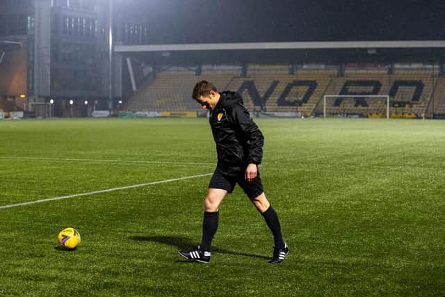 Referee Steven McLean inspects the pitch at Livingston.