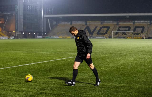 Referee Steven McLean inspects the pitch at Livingston.