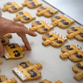 Bakers in London apply the finishing touches to Coronation-themed biscuits