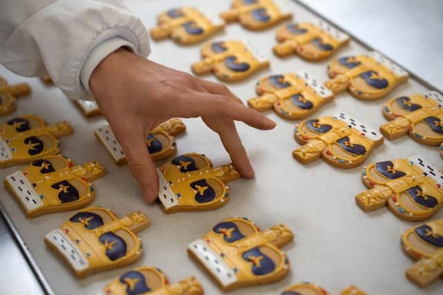 Bakers in London apply the finishing touches to Coronation-themed biscuits