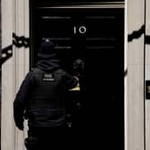 A police officer goes into 10 Downing Street in London. Picture: AP Photo/Matt Dunham