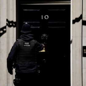 A police officer goes into 10 Downing Street in London. Picture: AP Photo/Matt Dunham