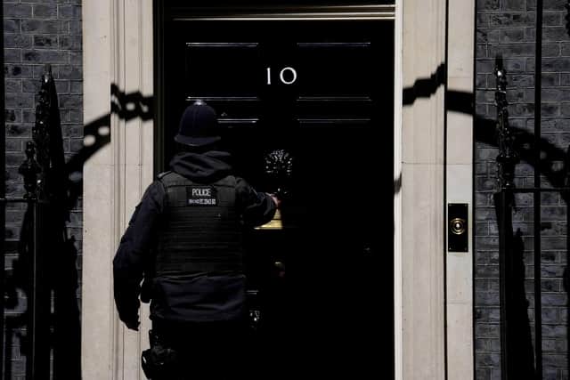 A police officer goes into 10 Downing Street in London. Picture: AP Photo/Matt Dunham