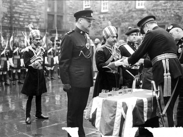 Lieutenant General Sir William F R Turner presenting visiting troops with silver statuettes of Edinburgh Castle for their contribution to the Military Tattoo in 1962.