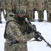 An instructor trains members of Ukraine's Territorial Defense Forces, volunteer military units of the Armed Forces, in a city park in Kyiv, Ukraine