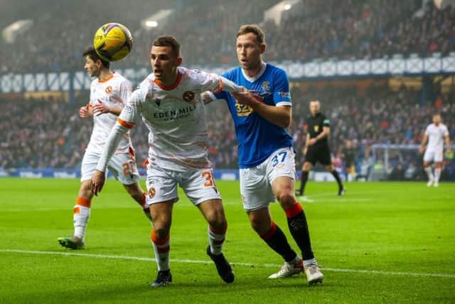 Scott Arfield challenges Dundee United's Darren Watson for possession during Rangers' 1-0 win over the Tannadice side at Ibrox on December 18. (Photo by Alan Harvey / SNS Group)