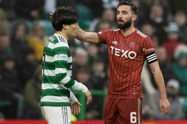 Celtic's Kyogo Furuhashi with Aberdeen's Graeme Shinnie after his demanded to enter the fray late on. (Photo by Craig Williamson / SNS Group)