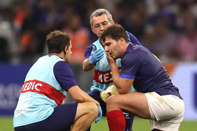 Antoine Dupont is treated by medics after picking up an injury in France's crushing win over Namibia.