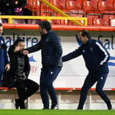 The two sets of coaching staff shake hands before the match during the Scottish Premiership match between Aberdeen and St Johnstone at Pittodrie Stadium on December 26, 2020, in Aberdeen, Scotland. (Photo by Craig Foy / SNS Group)