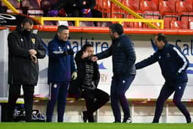 The two sets of coaching staff shake hands before the match during the Scottish Premiership match between Aberdeen and St Johnstone at Pittodrie Stadium on December 26, 2020, in Aberdeen, Scotland. (Photo by Craig Foy / SNS Group)