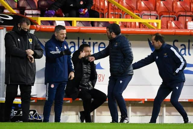 The two sets of coaching staff shake hands before the match during the Scottish Premiership match between Aberdeen and St Johnstone at Pittodrie Stadium on December 26, 2020, in Aberdeen, Scotland. (Photo by Craig Foy / SNS Group)