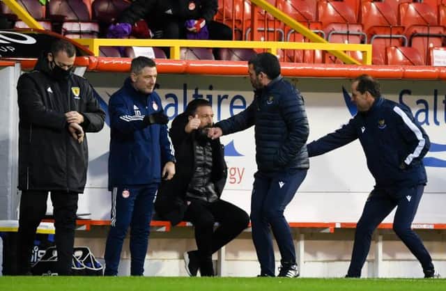 The two sets of coaching staff shake hands before the match during the Scottish Premiership match between Aberdeen and St Johnstone at Pittodrie Stadium on December 26, 2020, in Aberdeen, Scotland. (Photo by Craig Foy / SNS Group)