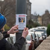 Local resident Alex Callaghan puts up a poster near the last known sighting of Alice Byrne on Marlborough Street (Photo: Andrew O'Brien).