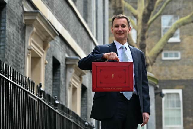 Chancellor Jeremy Hunt poses with the red Budget Box as he leaves 11 Downing Street to present the government's annual Budget to Parliament. Photo: JUSTIN TALLIS/AFP via Getty Images