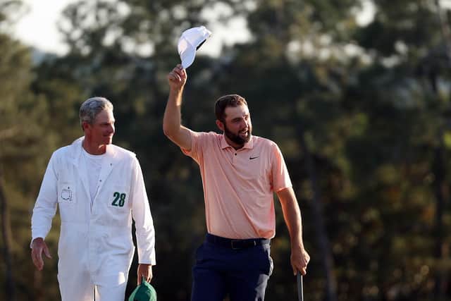 Scottie Scheffler and caddie Ted Scott celebrate on the 18th green at the end of the 88th edition of The Masters. Warren Little/Getty Images.