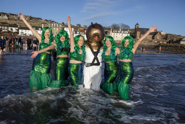 Over one hundred people take part in the Kinghorn Loony Dook New Years Day swim on the Fife coast of the Firth of Forth