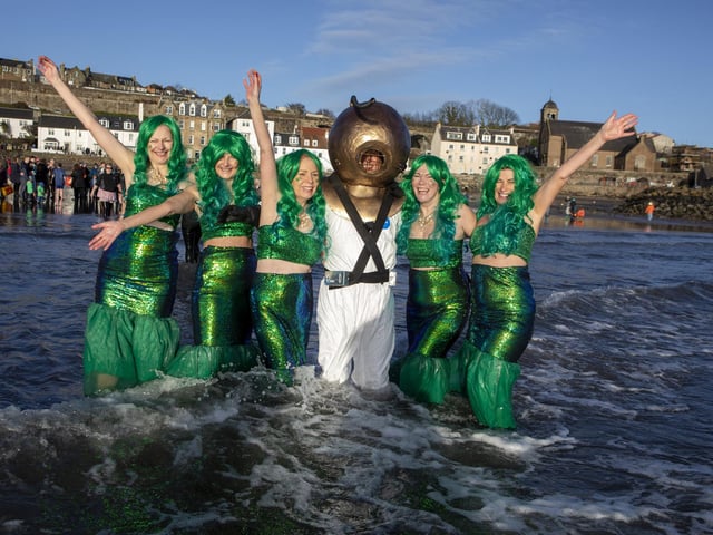 Over one hundred people take part in the Kinghorn Loony Dook New Years Day swim on the Fife coast of the Firth of Forth