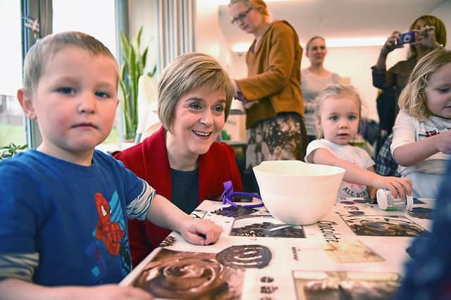 First Minister Nicola Sturgeon with children in 2014, the year before she asked to be judged on Education (Picture: Getty)