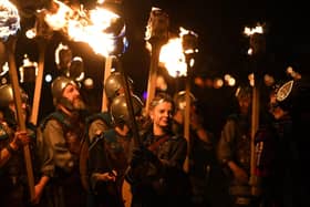 Members of the Up Helly Aa 'Jarl Squad' parade through the streets of in Lerwick, Shetland Islands in January. The event is widely used to promote Shetland as a tourist destination. Meanwhile, budgets to manage visitors on the ground have been cut.  (Photo by ANDY BUCHANAN/AFP via Getty Images)