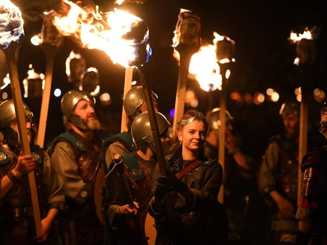Members of the Up Helly Aa 'Jarl Squad' parade through the streets of in Lerwick, Shetland Islands in January. The event is widely used to promote Shetland as a tourist destination. Meanwhile, budgets to manage visitors on the ground have been cut.  (Photo by ANDY BUCHANAN/AFP via Getty Images)