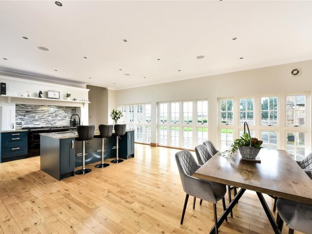 The dining kitchen has full length windows to the west, overlooking the rear courtyard.