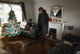 Carol Watters inspects flood damage to her home in Cupar caused by Storm Gerrit (Picture: Jeff J Mitchell/Getty Images)