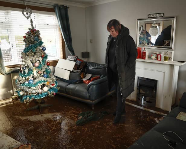 Carol Watters inspects flood damage to her home in Cupar caused by Storm Gerrit (Picture: Jeff J Mitchell/Getty Images)
