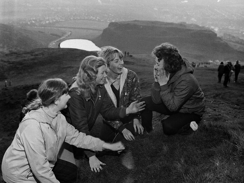 Four girls wash their faces in the morning dew as the sun comes up on May Day morning on Arthur's Seat in 1965.