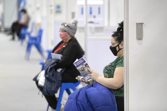Health and social care staff wait in the rest area after receiving their coronavirus vaccines at the NHS Louisa Jordan Hospital in Glasgow, as part of a mass vaccination drive by NHS Greater Glasgow and Clyde. Picture date: Saturday January 23, 2021.