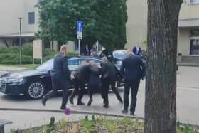 Security personnel carry Slovakia's Prime Minister Robert Fico towards a vehicle after he was shot on Wednesday (Picture: RTVS/AFP via Getty Images)