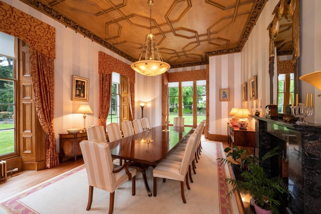 The impressive dining room features a magnificent feature fireplace.