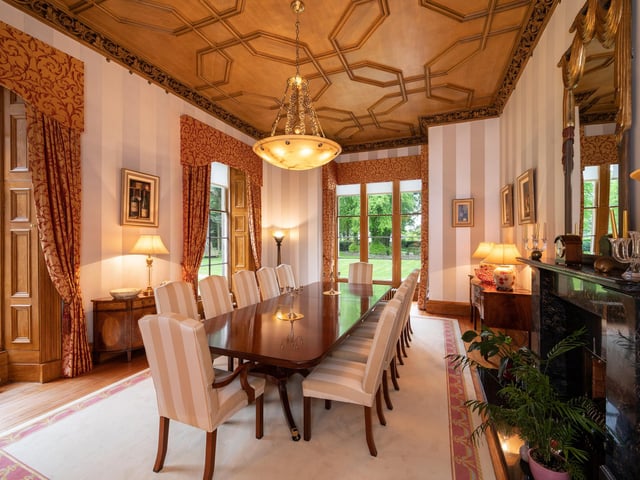 The impressive dining room features a magnificent feature fireplace.