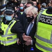 Prime Minister Boris Johnson is surrounded by police as he arrives at Glasgow Central station on November 9, 2021. Picture: Peter Summers/Getty Images