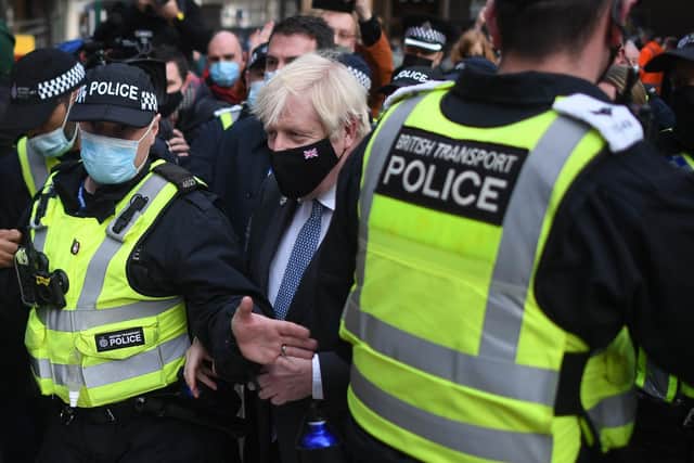 Prime Minister Boris Johnson is surrounded by police as he arrives at Glasgow Central station on November 9, 2021. Picture: Peter Summers/Getty Images
