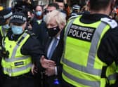 Prime Minister Boris Johnson is surrounded by police as he arrives at Glasgow Central station on November 9, 2021. Picture: Peter Summers/Getty Images