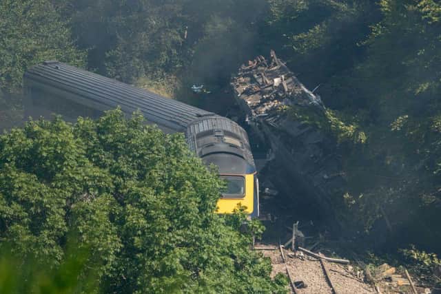 Three people, including the train’s driver Brett McCullough, and its conductor Donald Dinnie, were killed in the crash when the train was hit by a landslide. Six other people were taken to hospital. (Photo by MICHAL WACHUCIK/AFP via Getty Images)