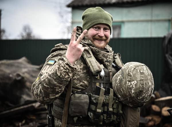 A Ukrainian soldier flashes a V-for-victory sign during the defence of Kyiv in March last year (Picture: Aris Messinis/AFP via Getty Images)