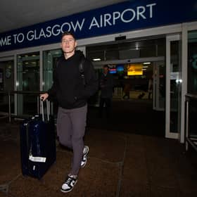 Hibs' Kevin Nisbet arrives at Glasgow Airport after a proposed move to Millwall broke down.