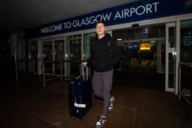 Hibs' Kevin Nisbet arrives at Glasgow Airport after a proposed move to Millwall broke down.