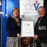 Aberdeenshire Provost Judy Whyte receives a framed certificate from VHS chairman, Group Captain Bob Kemp, in recognition of the council's support. Image: Veterans Housing Scotland