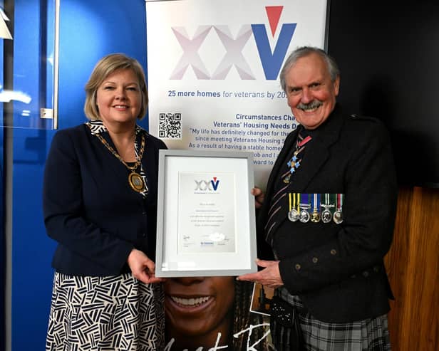 Aberdeenshire Provost Judy Whyte receives a framed certificate from VHS chairman, Group Captain Bob Kemp, in recognition of the council's support. Image: Veterans Housing Scotland